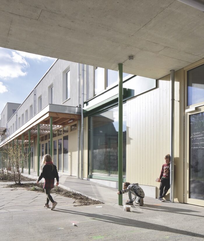 Een vederlichte pergola, met planken op dunne stalen poten ondergraaft de massiviteit van het gebouw. Daar etaleren de architecten hun zin voor elementair detail, voor schoonheid. ©Filip Dujardin
